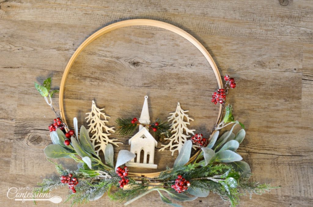 Christmas Embroidery Hoop Wreath will look perfect on your front door! This wreath is super easy and very inexpensive. Some of the supplies were even bought at the Dollar Store. You won't find an easier DIY Christmas project! #Christmaswreath #diycrafts #Christmasdecorating #Christmastime #ChristmasEve #Christmas