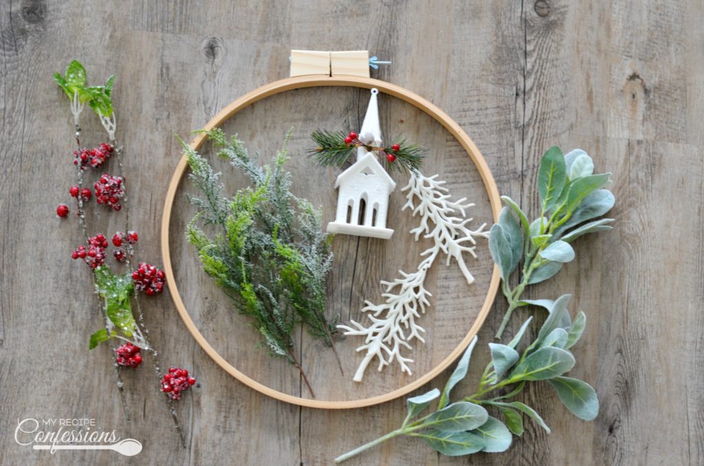 Christmas Embroidery Hoop Wreath will look perfect on your front door! This wreath is super easy and very inexpensive. Some of the supplies were even bought at the Dollar Store. You won't find an easier DIY Christmas project! #Christmaswreath #diycrafts #Christmasdecorating #Christmastime #ChristmasEve #Christmas