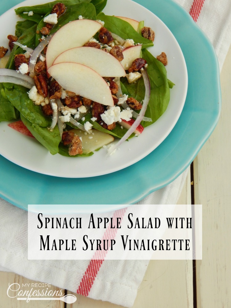 Spinach Apple Salad with Maple Syrup Vinaigrette- Apples, onions, feta cheese, and candied pecans over a bed of spinach with a maple syrup vinaigrette drizzled over the top. This is the best salad recipe! The dressing is super easy to make and it will rock your world!
