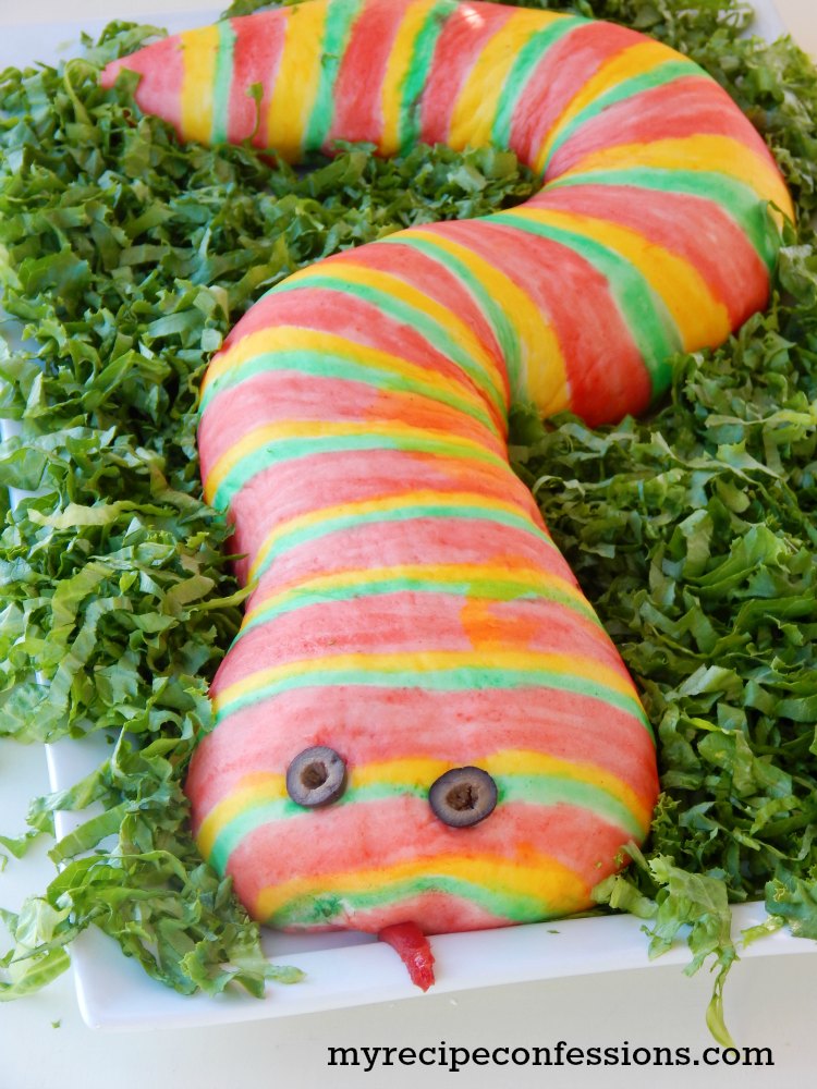Pizza Stuffed Snake- This easy to follow recipe and tutorial is my boys favorite! You can customize it with your favorite pizza toppings. My kids love to help paint the snake. You will be shocked how simple the food coloring paint is to make. This snake is a great main dish to serve at a Halloween party, birthday party, or Harry Potter party. Serve it with a side of blood a.k.a marinara sauce for a huge party hit! 