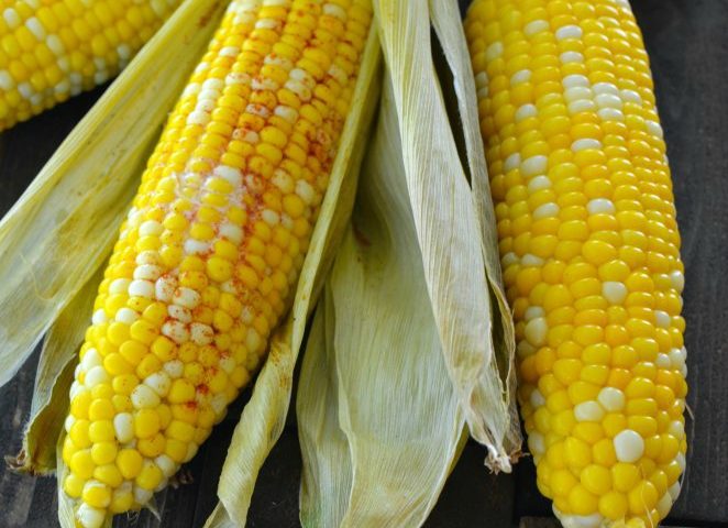 Easy Roasted Corn on the Cob is the easiest way to cook corn on the cob. There is no need to husk the corn before cooking, and it bakes in under 30 minutes. Once the corn is cooked the husk and silk practically slip right off. After trying this recipe, you will never boil corn again!