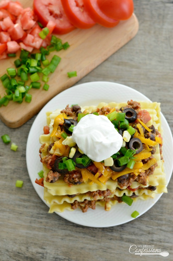 Taco Lasagna is a quick and easy family friendly recipe. If you love Mexican food, you will love the layers of noodles, ground beef, beans, cheese and more. This recipe is going to rock your world!