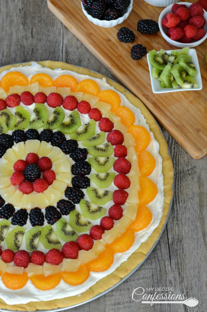 Easy Classic Fruit Pizza is an easy recipe that uses the best sugar cookie recipe for the crust. The cream cheese frosting tastes just like cheesecake. This gorgeous dessert is absolutely divine!